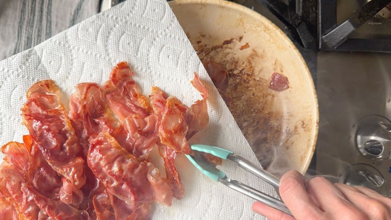 Crispy prosciutto slices on paper towel-lined plate