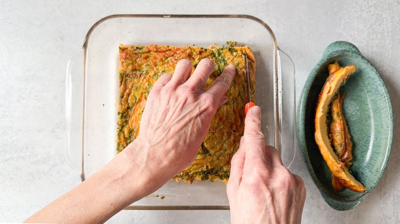 Trimming baked eggs in square glass baking dish