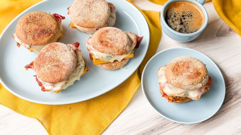 High-protein English muffin sandwiches on platter and plate with coffee cupt
