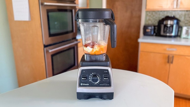 Eggs, cheeses, and spices in blender container