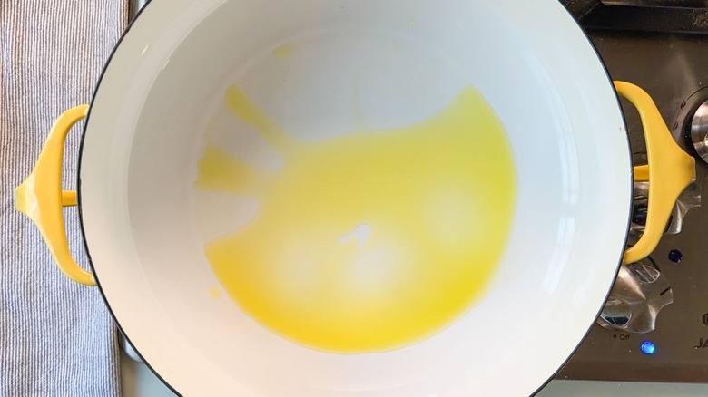 Olive oil in large yellow pot on stovetop