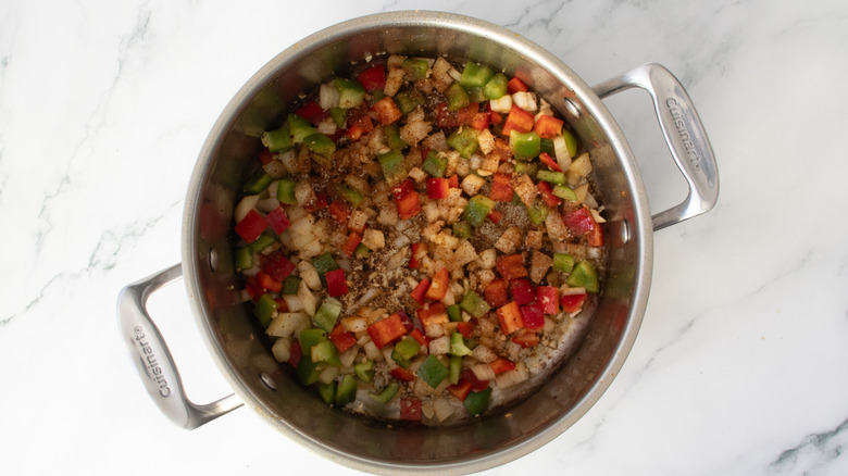 chopped partially cooked vegetables in a metal pot