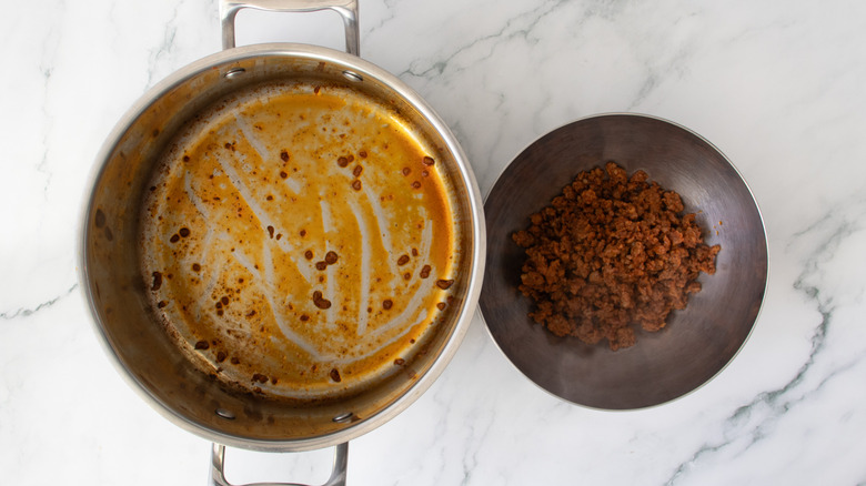 Mexican-style chorizo in a bowl next to a metal pot