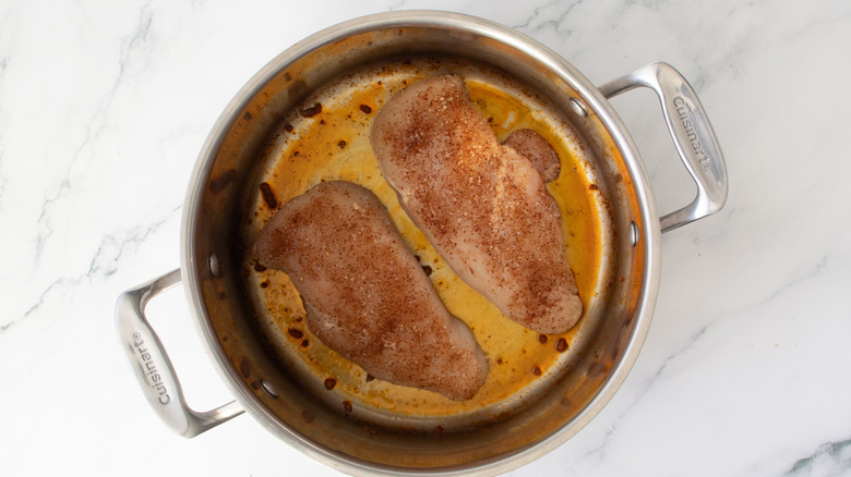 chicken breasts in a metal pot
