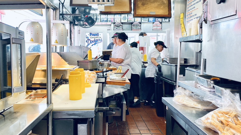 Kitchen staff working behind the counter at Pink's Hot Dogs