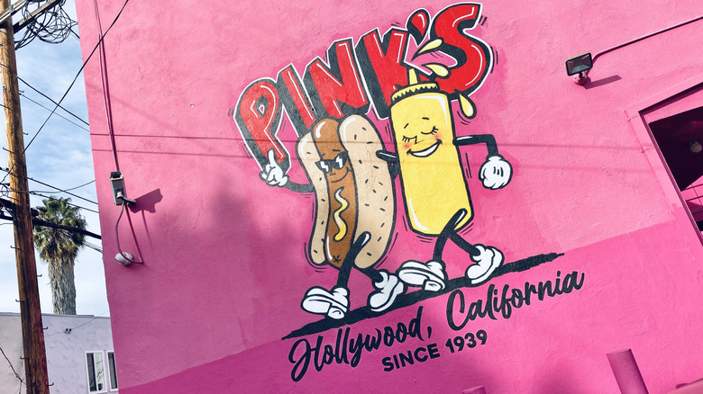 Hot dog and mustard mural on pink wall at Pink's Hot Dogs