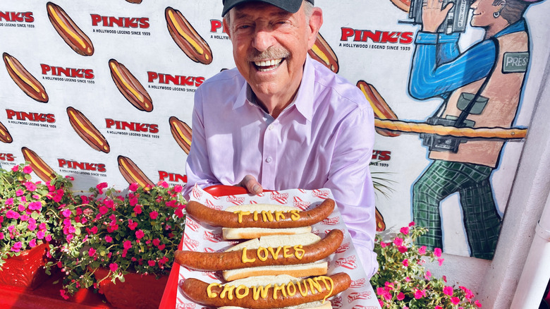 Richard Pink holds hot dogs at Pink's in Los Angeles