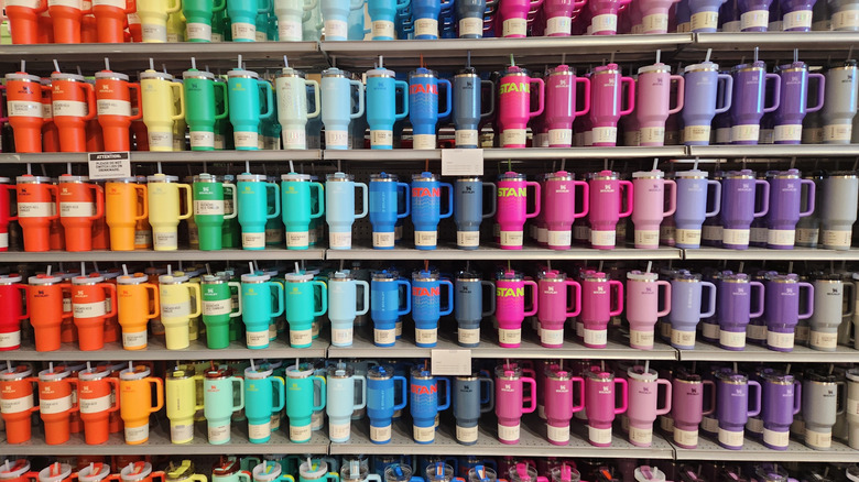Store shelf filled with Stanley tumblers in a variety of colors
