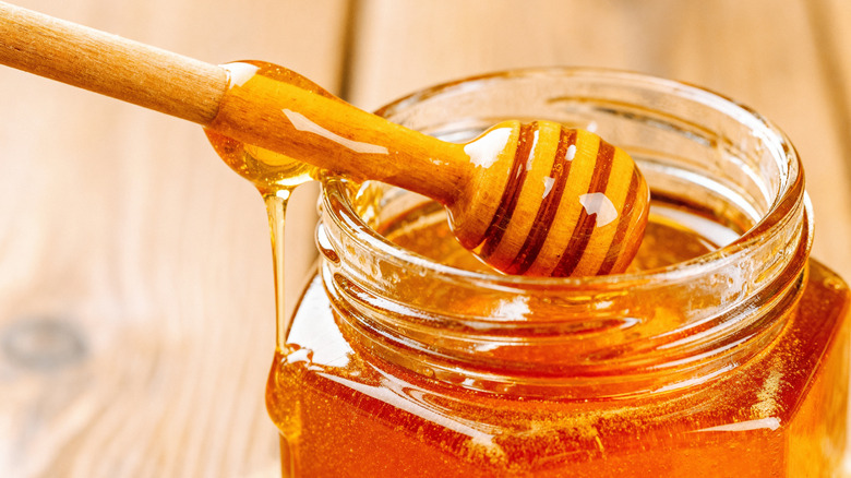 liquid honey in a glass jar