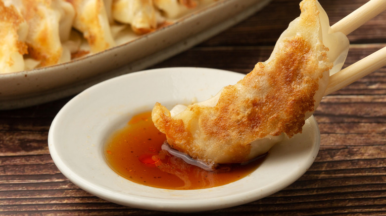 Gyoza dipped in sauce