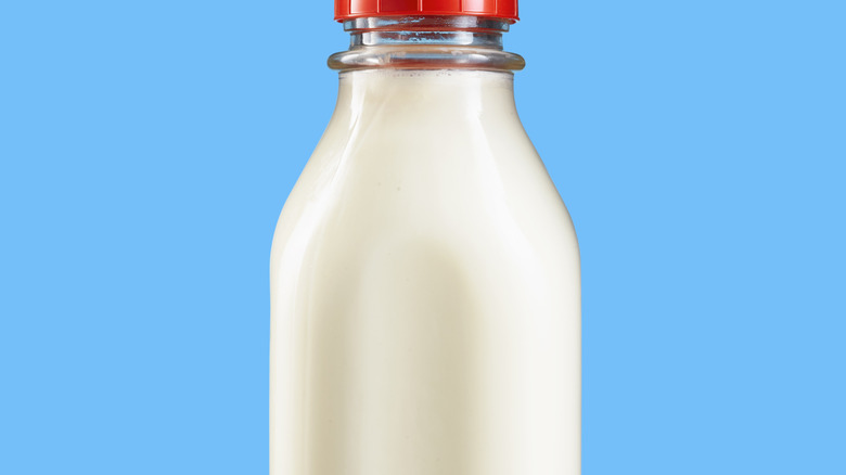 A milk bottle against a bright blue background
