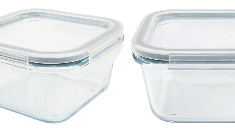 Glass food containers with lids against a white background