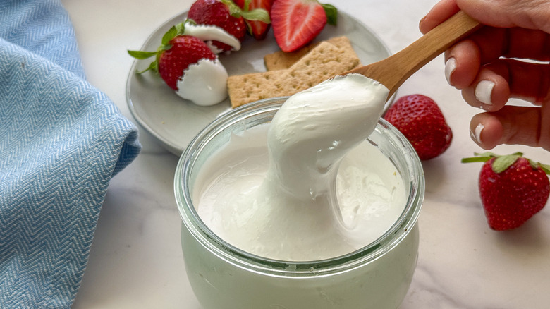 hand holding a spoon of marshmallow fluff