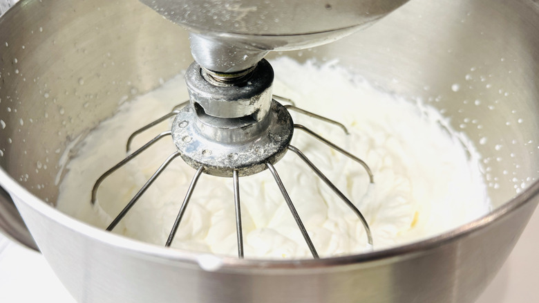 Whipping cream in a mixing bowl
