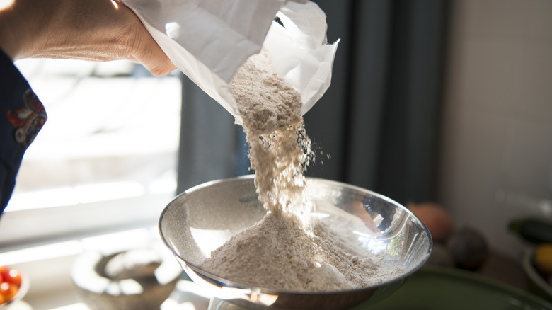 weighing flour into metal bowl