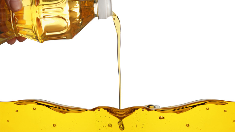 cooking oil pouring into a pool of oil