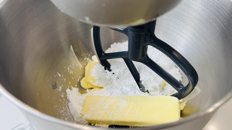 Butter and confectioners' sugar in mixing bowl