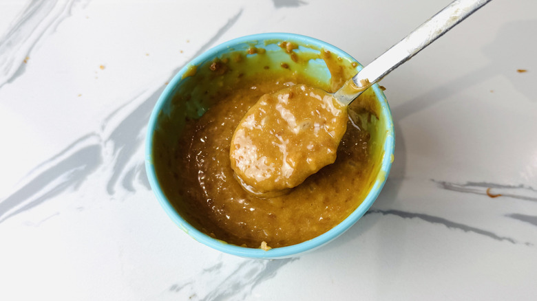 Coconut mixed into melted caramel