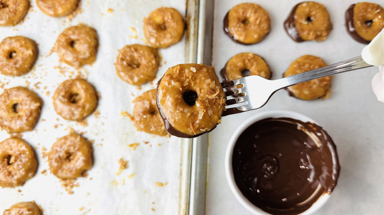 Homemade Samoas dipped into melted chocolate
