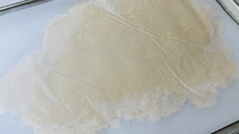 Chilled cookie dough rolled between parchment