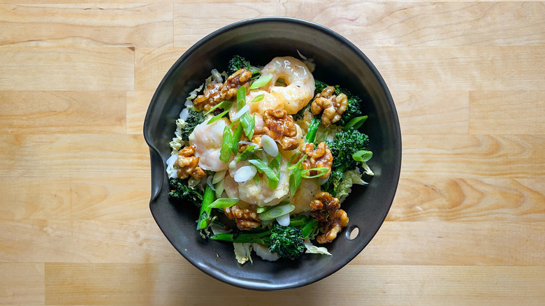 Honey walnut shrimp in bowl with garnishes