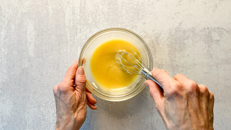 Mixing mayonnaise sauce for honey walnut shrimp on countertop