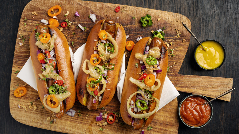 Three artisan hot-dogs in brioche rolls