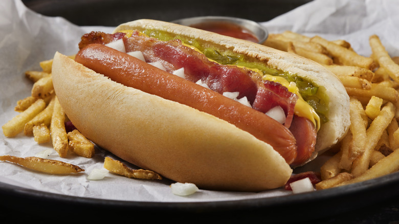 A split hot dog with fries and toppings.