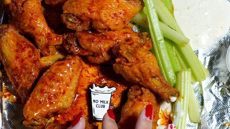 Hot Ones wings and celery with ranch and a "no milk" pin