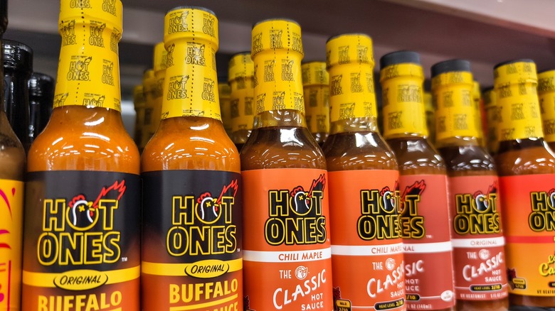 Hot Ones hot sauce lineup on grocery store shelf