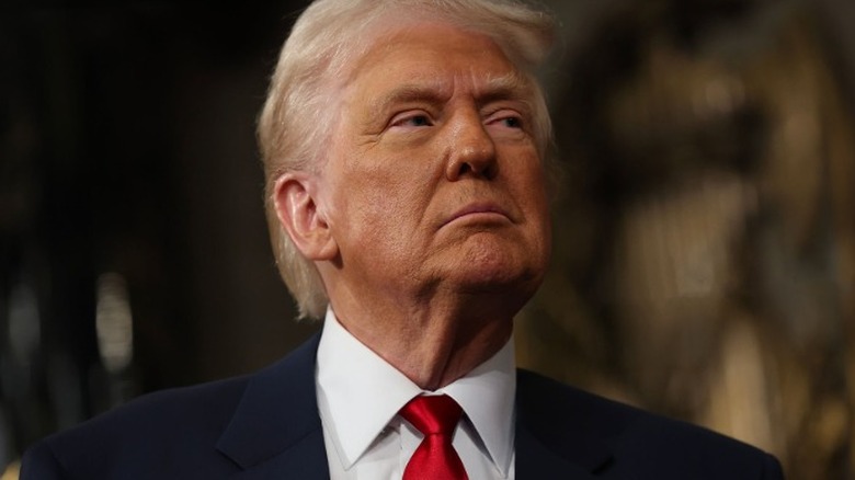 Donald Trump looking sideways wearing red tie
