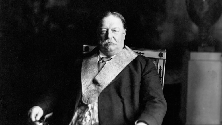 William Howard Taft posing for a photo sitting in a chair