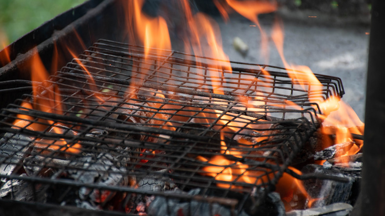 heated grill with some flames.