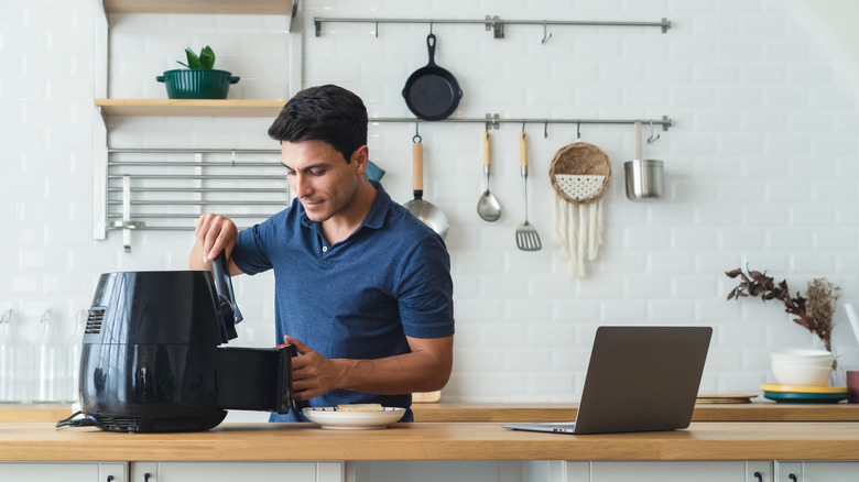 Person cooking with air fryer