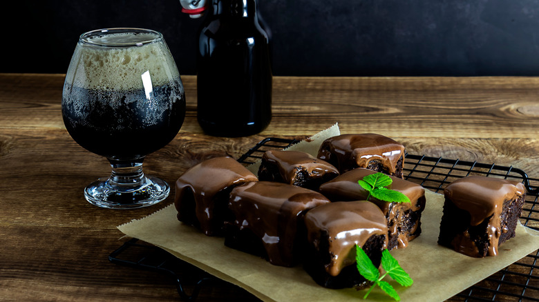 Stout beer in a glass and brownies on a wire rack