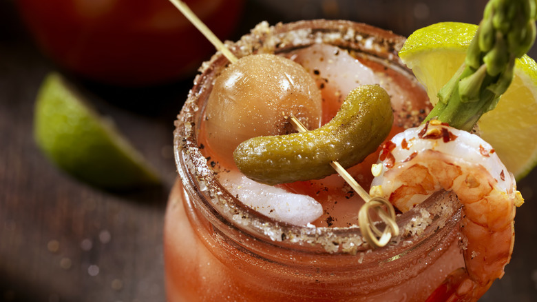 A bloody Mary garnished with shrimp and vegetables