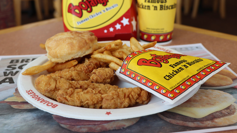Bojangles chicken tenders, biscuit, and fries on a plate