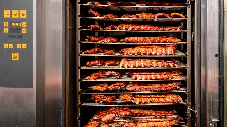 full racks of ribs in a commercial smoker