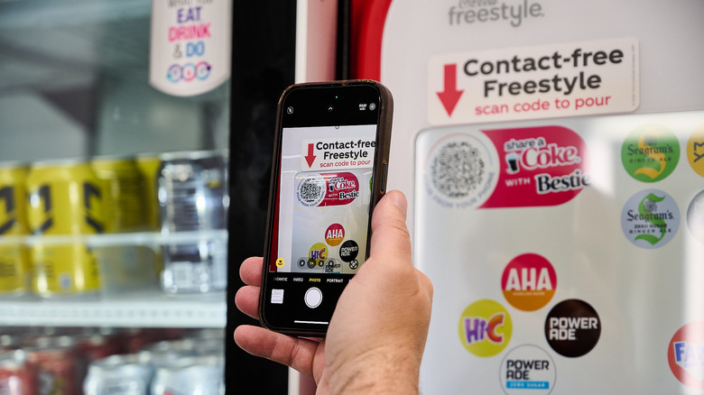 A man scanning a QR code on a phone