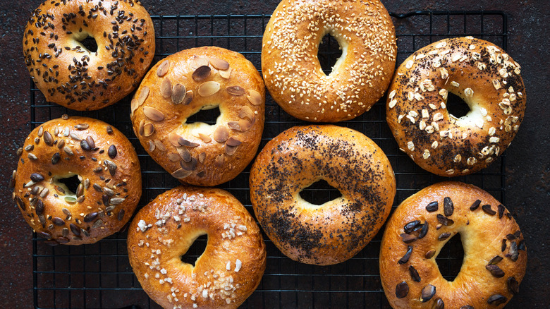 Various flavors of bagels on a drying rack