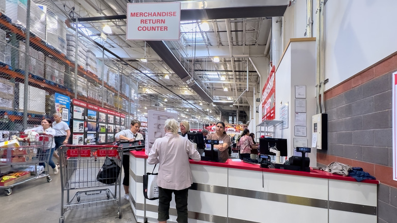 A return counter inside a Costco store with several people around it