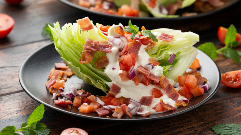 wedge salad with tomatoes, bacon, and blue cheese dressing