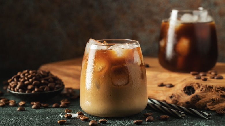 Iced coffee in a glass with coffee beans