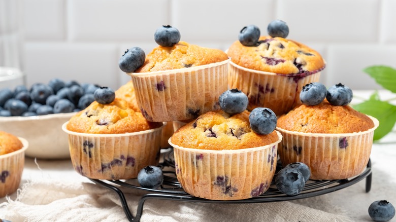 Blueberry muffins on wire rack.