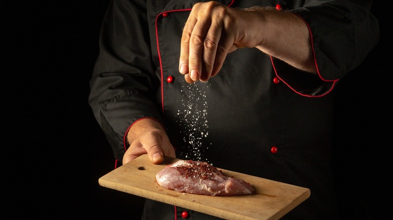 Chef seasoning meat