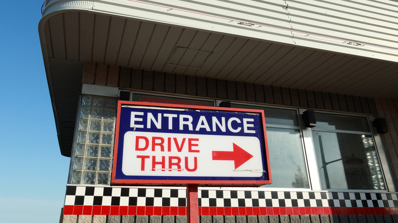drive-thru entrance sign with arrow