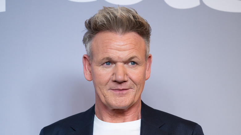 Gordon Ramsay in a black suit jacket and white T-shirt looking away from the camera