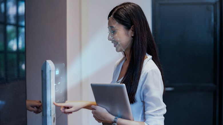 Facial recognition kiosk showing facial data points on person