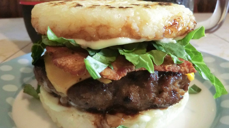 A rice burger featuring two rice "buns" and a standard burger patty with toppings