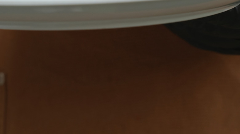 An islak burger on a plate with pickled vegetables